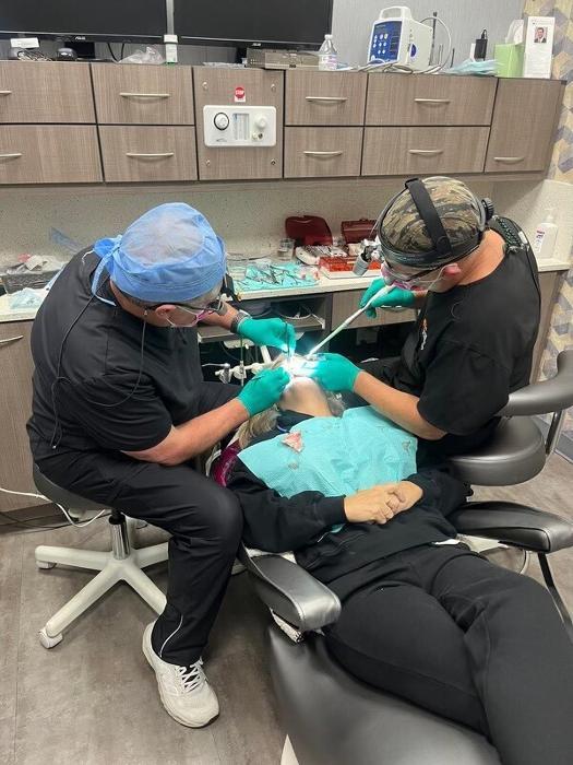 two dentists working on a patient